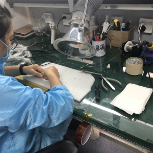Technician assembling an ultrasound probe in the Akicare quality control workshop
