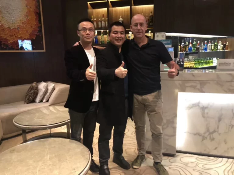 Akicare representative with business contacts in a hotel lounge