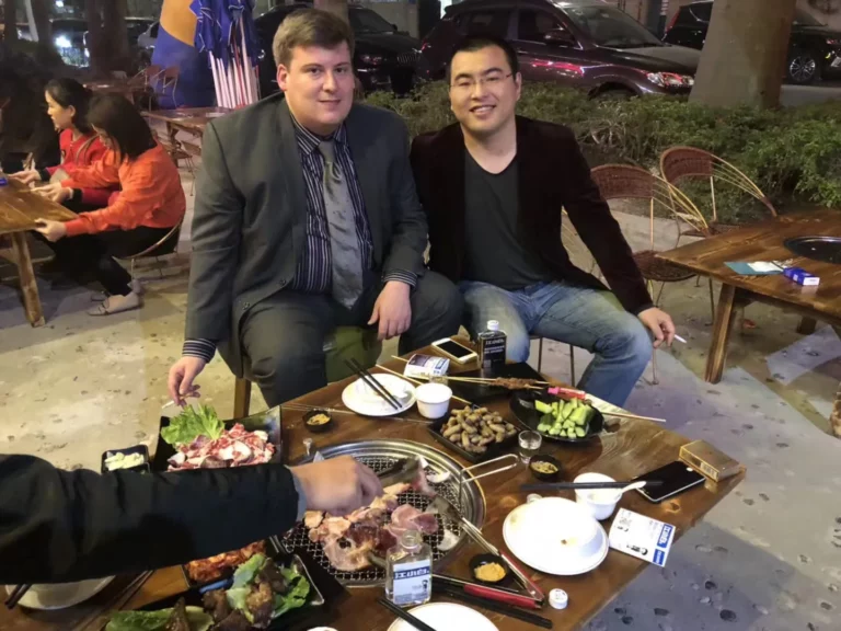Akicare representative and a business contact at an outdoor restaurant table