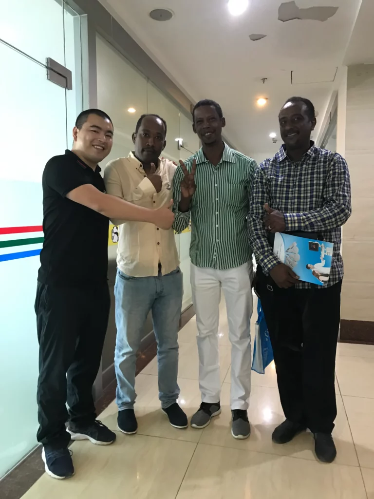 Akicare representative greeting business contacts in an office lobby