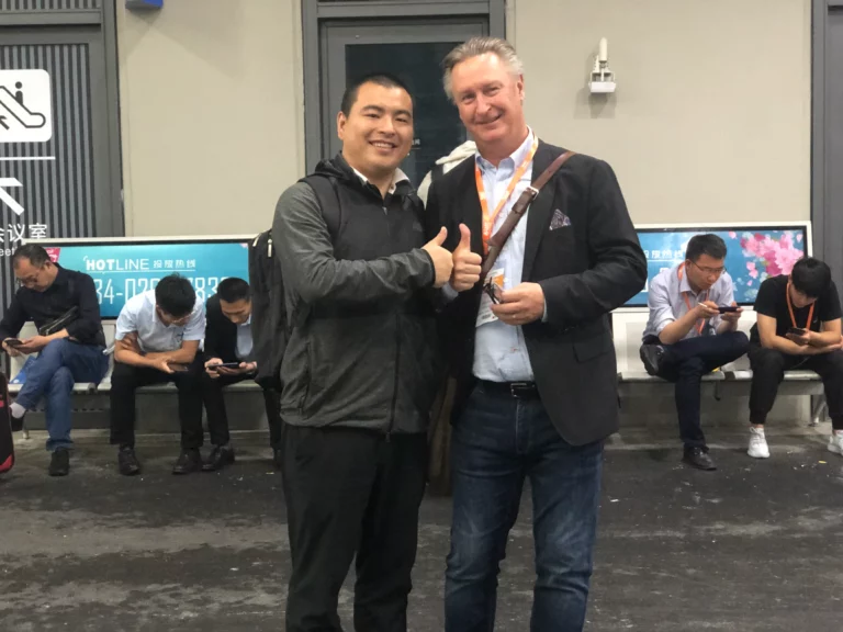 Akicare representative with a business contact in a medical imaging exhibition hall