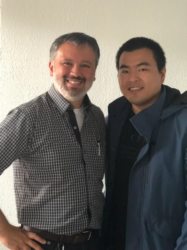 Akicare representative with a business contact in an office