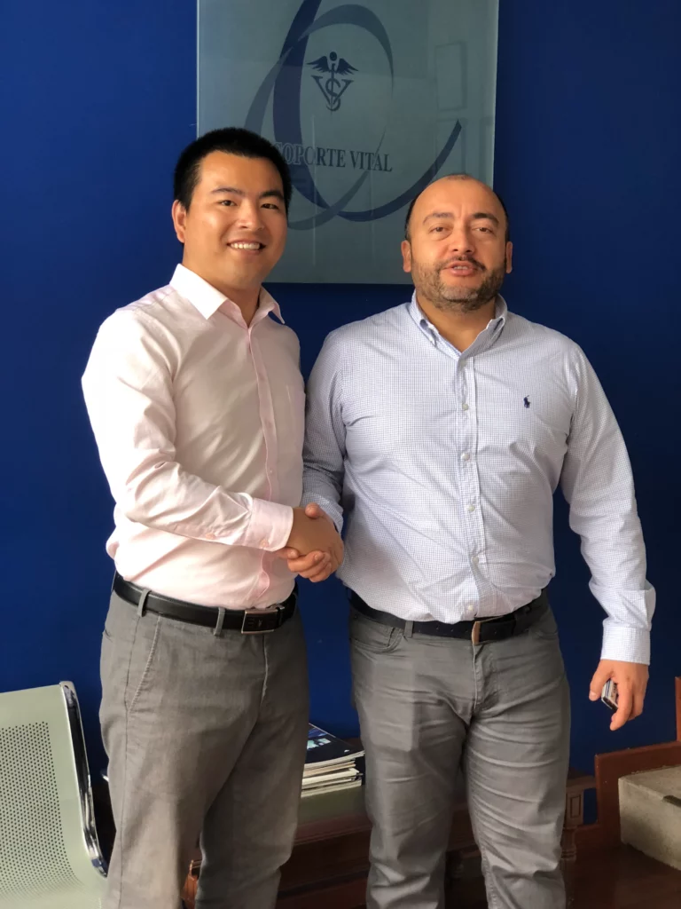 Akicare representative shaking hands with a business contact in an office