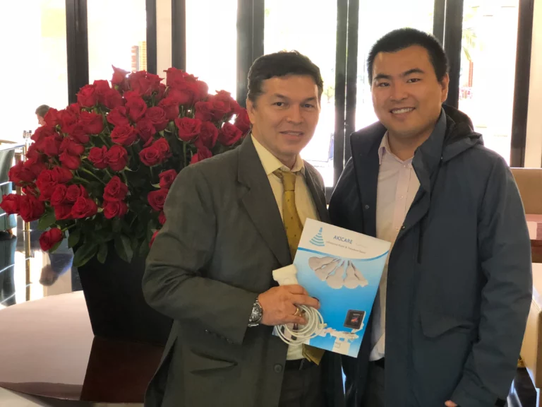 Akicare representative holding a boxed ultrasound probe with a business contact