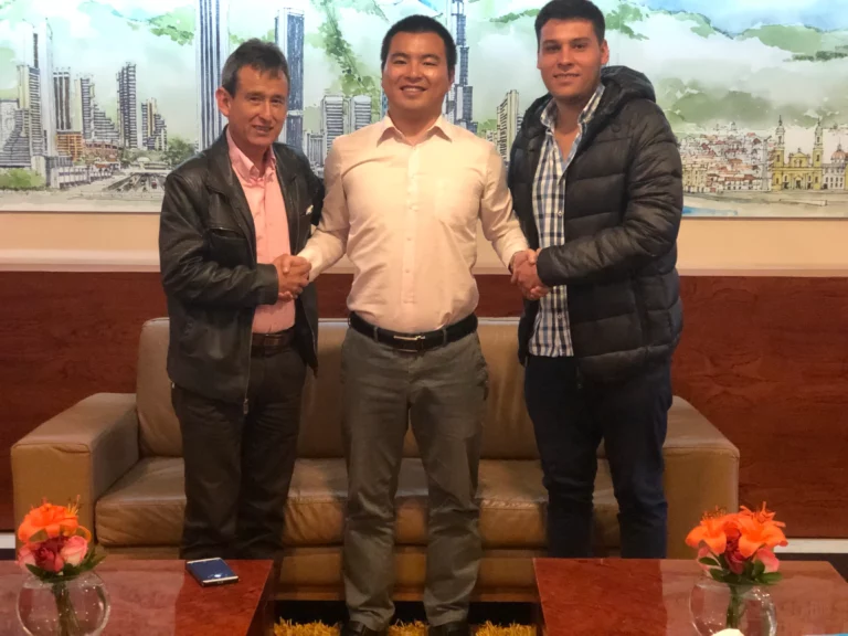 Akicare representative with two business contacts in a hotel lounge