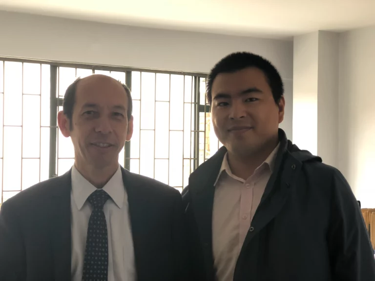 Akicare representative with a business contact in an office