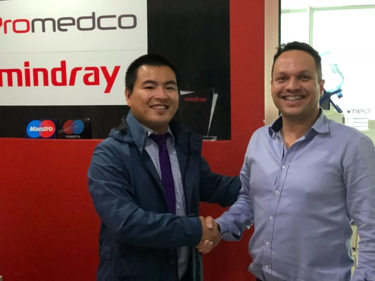 Akicare representative shaking hands with a business contact at a distributor office