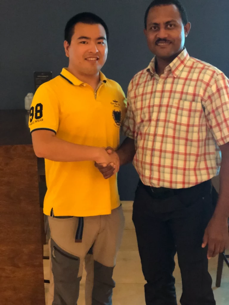 Akicare representative shaking hands with a business contact during a visit