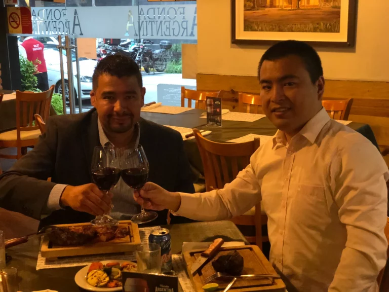 Akicare representative and a business contact at a restaurant table