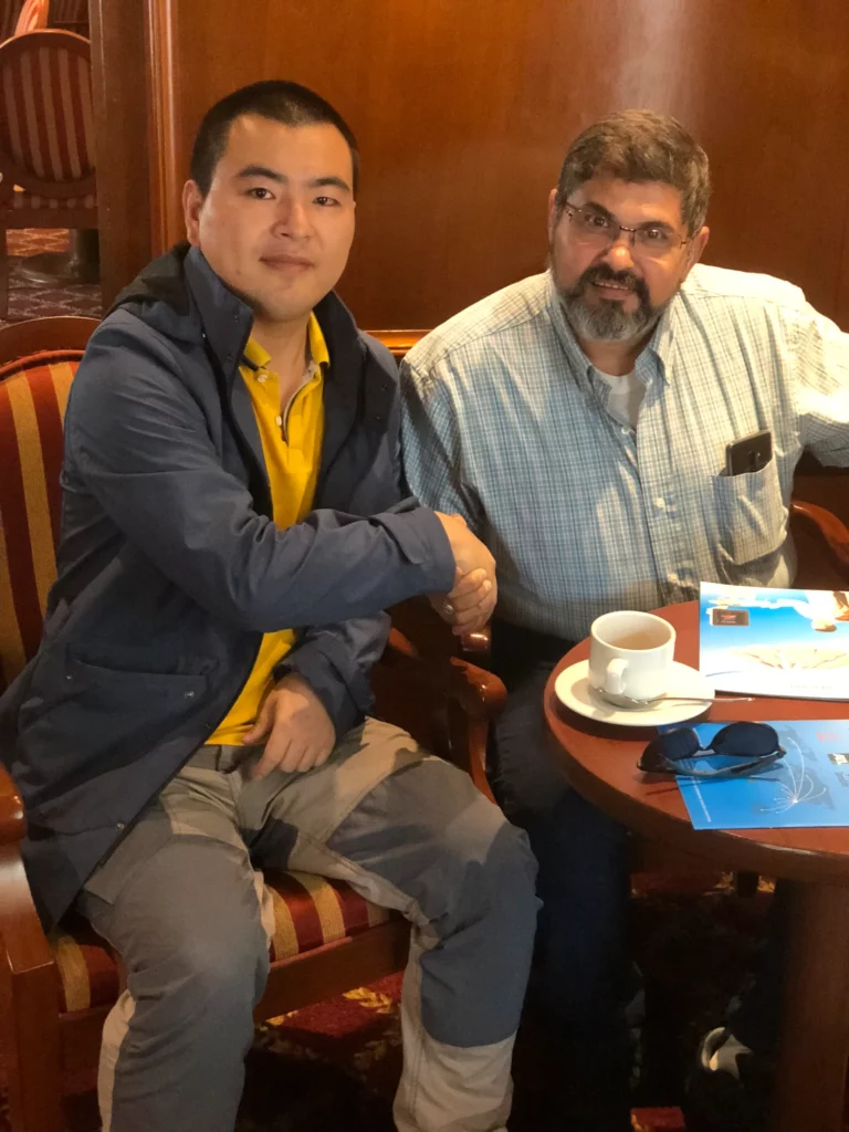 Akicare representative in conversation with a business contact during a visit