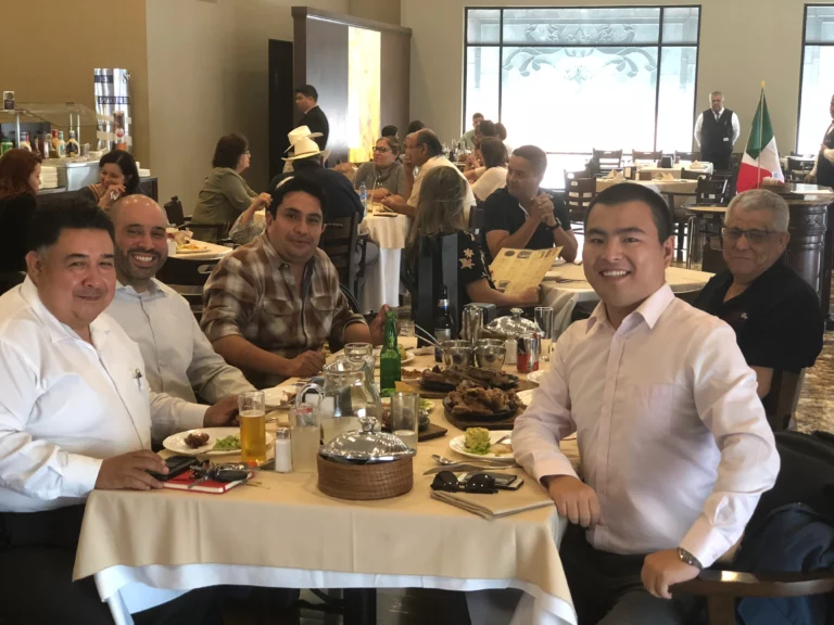 Akicare representative with business contacts at a restaurant table