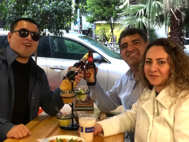 Akicare representative with business contacts at an outdoor restaurant table