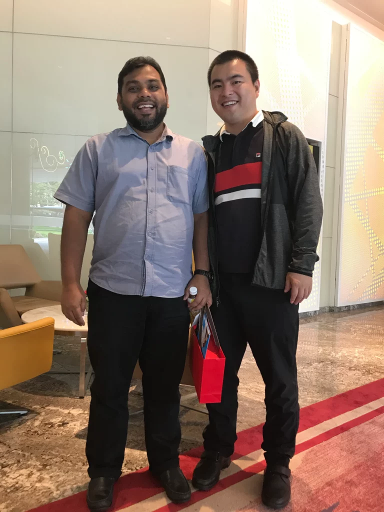 Akicare representative with a business contact in a hotel lobby