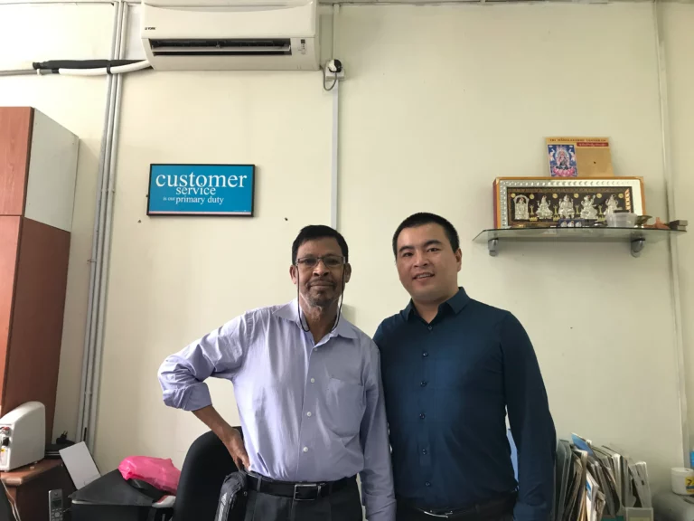 Akicare representative with a business contact in an office