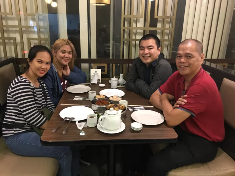 Akicare representative with business contacts at a restaurant table