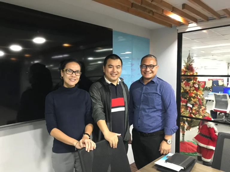 Akicare representative with business contacts in an office