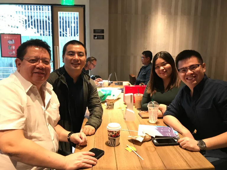 Akicare representative with business contacts at a meeting table